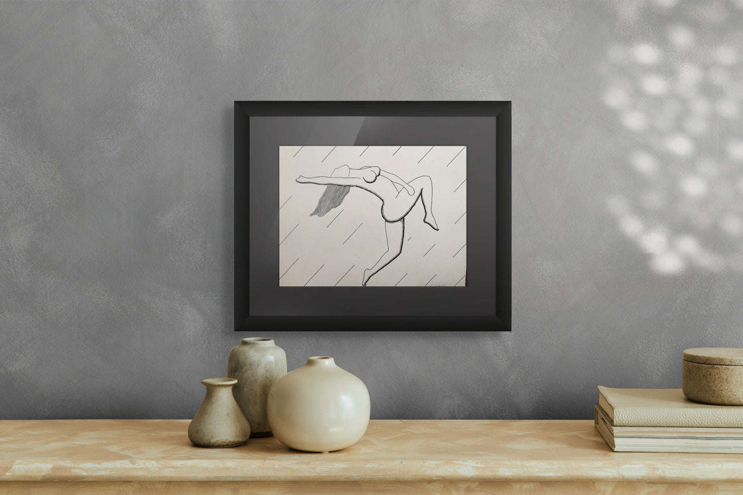 Framed print of a dancer, her body arched in tension and release, bending gracefully between strength and surrender.