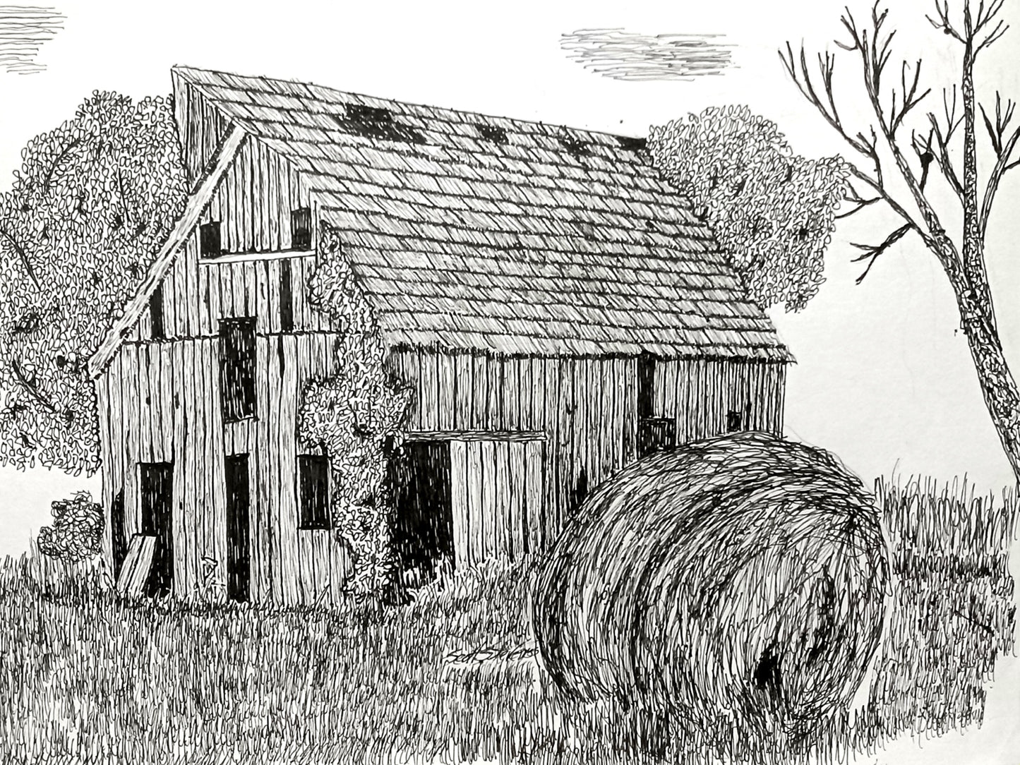Black and white illustration of a barn with a hay bale in a field