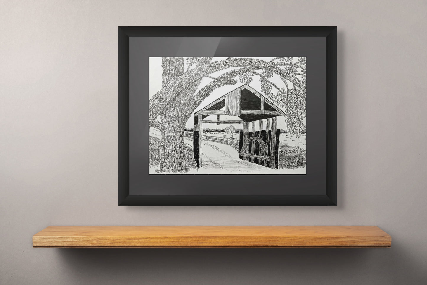 Framed print of a covered bridge drawn with pen and ink.