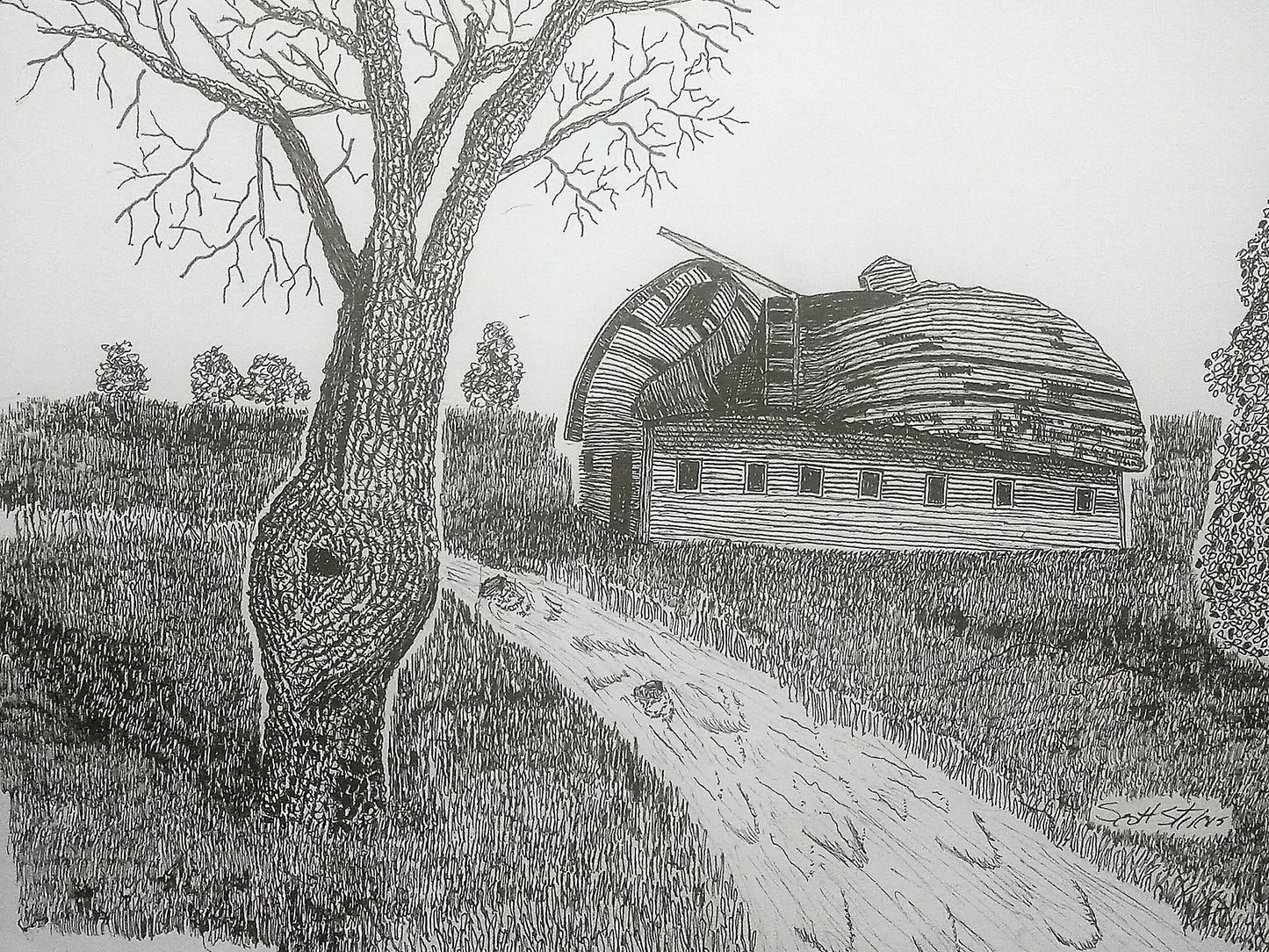 A black and white handcrafted pen and ink art print of an old barn with a tree and a stream in the foreground.