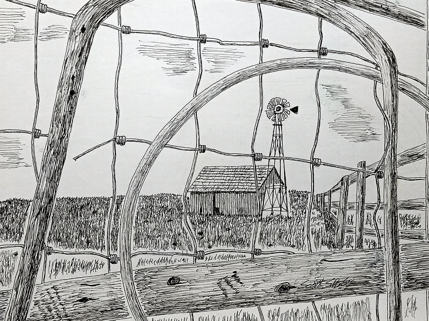 Black and white illustration of a windmill and barn through a circular wooden frame.