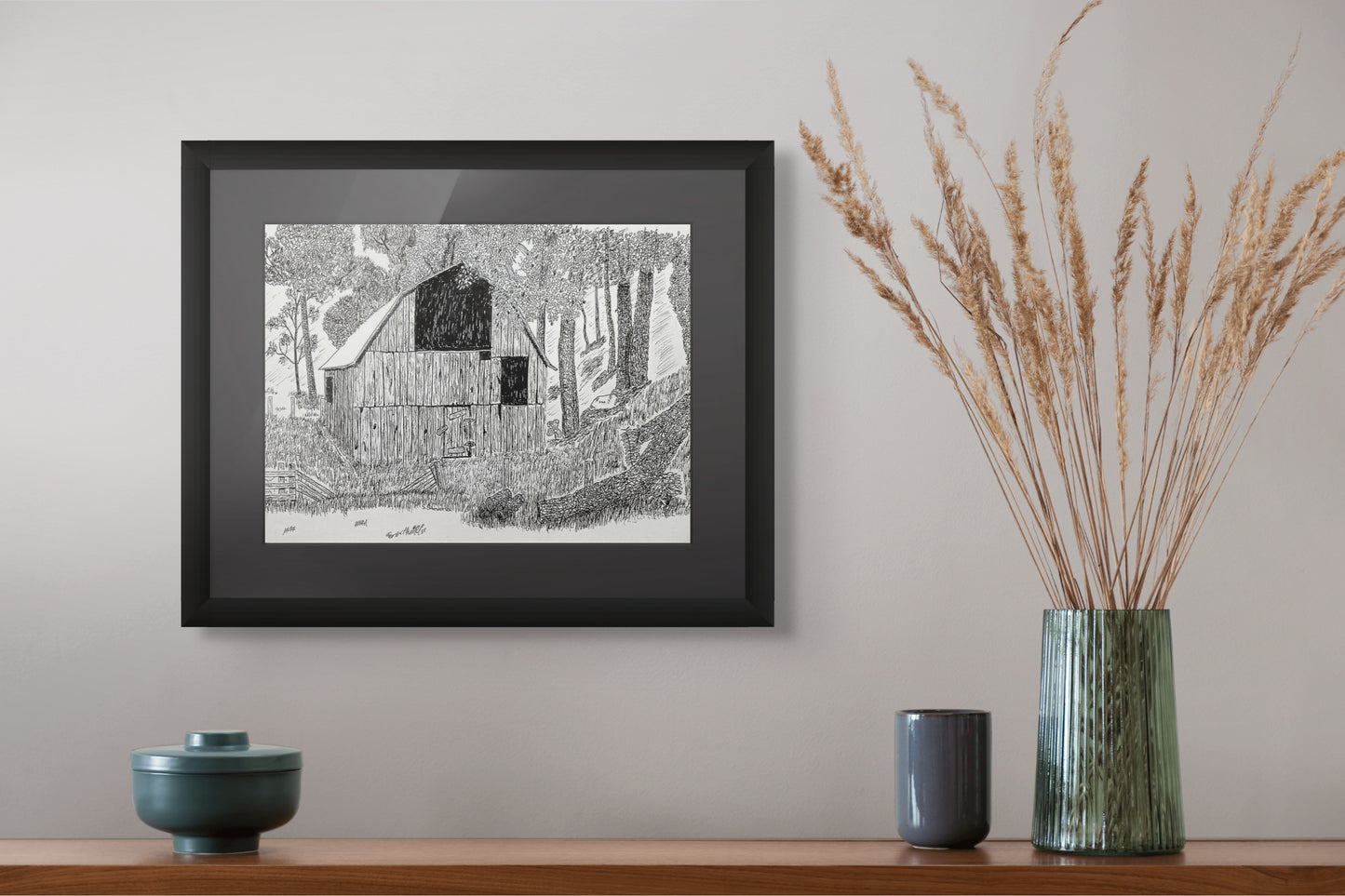 Framed print of a pen and ink drawing of an old barn set in the woods.