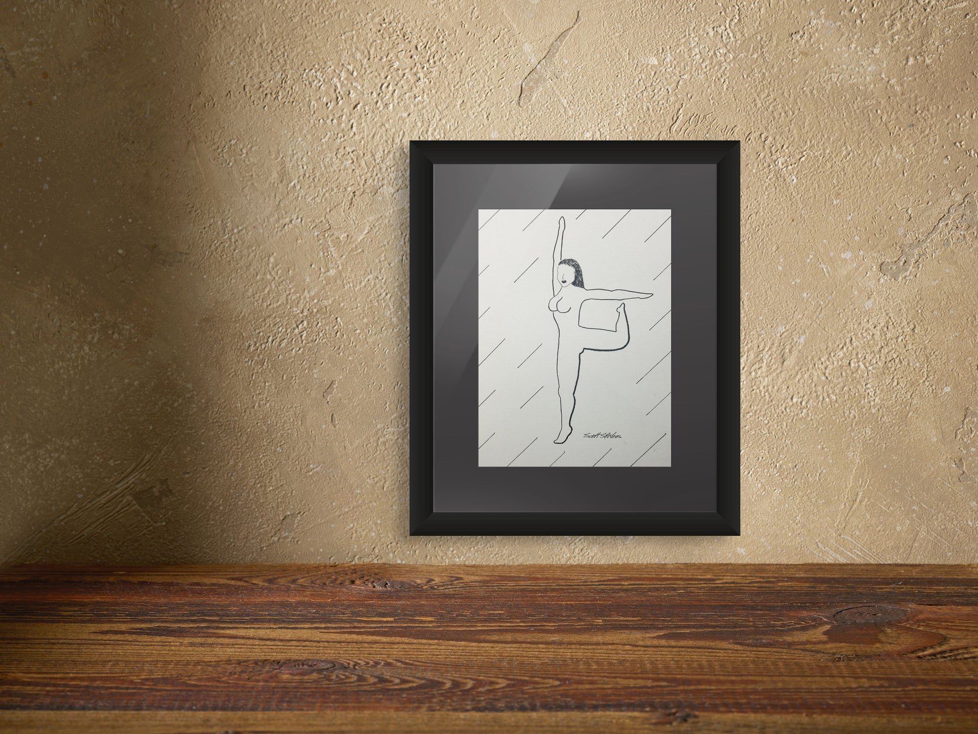 Framed artwork of a woman dancing on a textured wall.