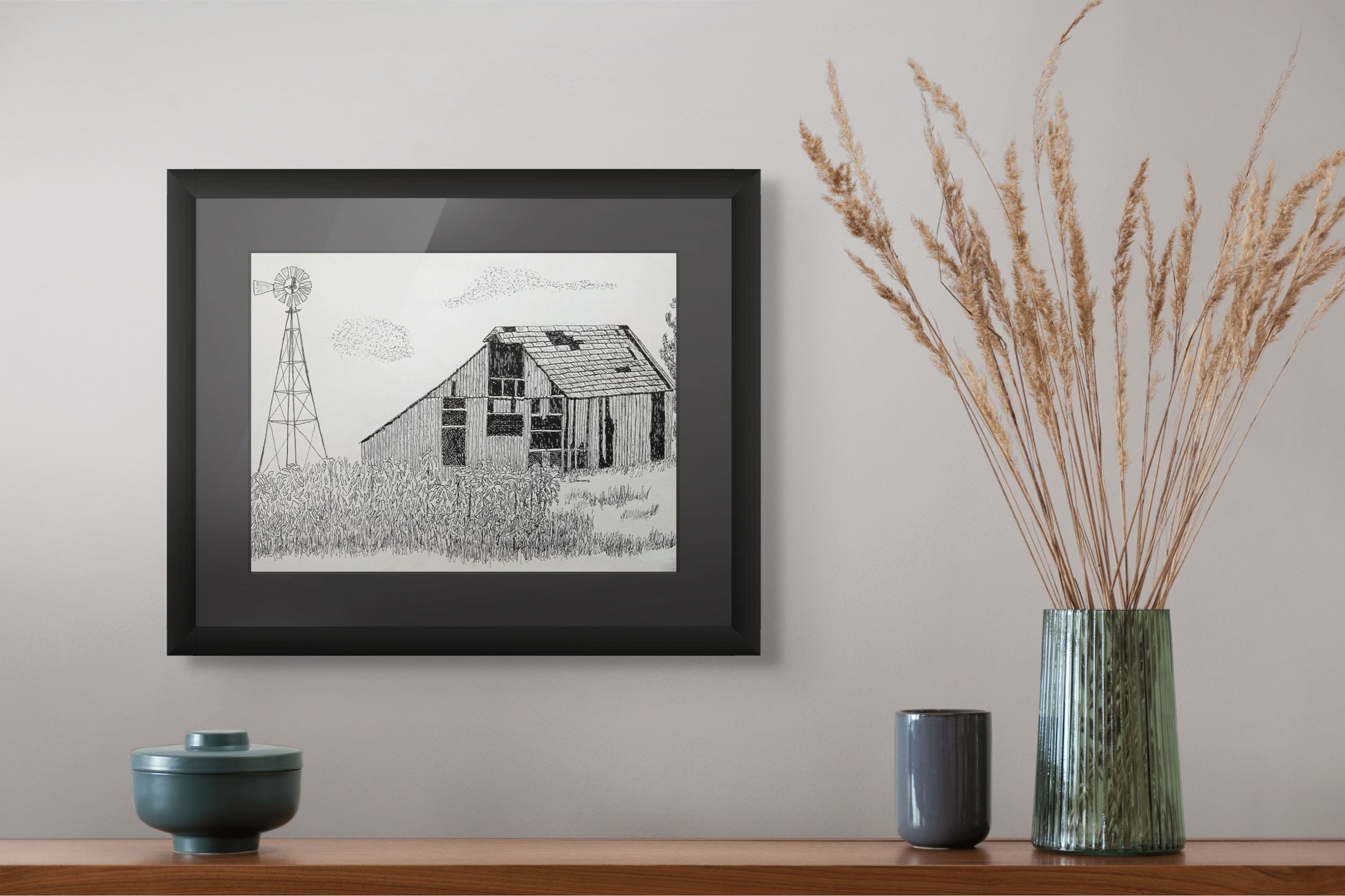 Framed print of pen and ink drawing of an old barn and windmill in a cornfield.