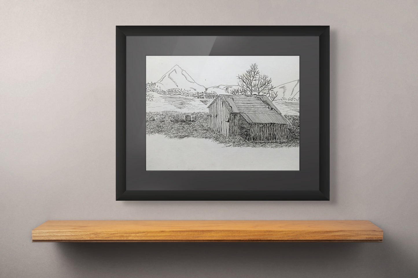 Framed black and white art print of an old cottage next to a river.
