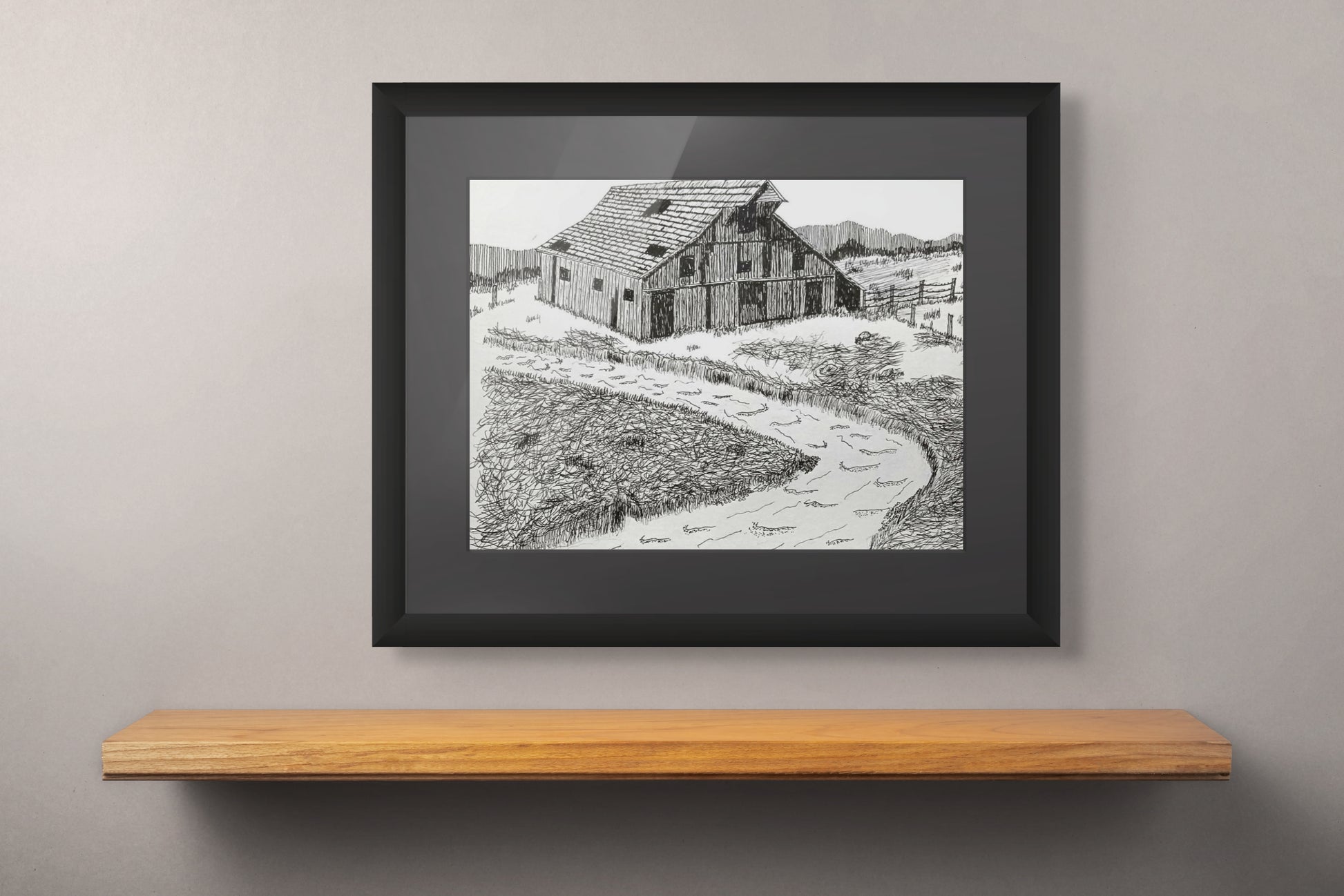 Framed pen and ink print of a running stream and an old barn.